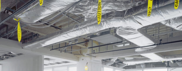 Heat recovering system installed in a factory ceiling.