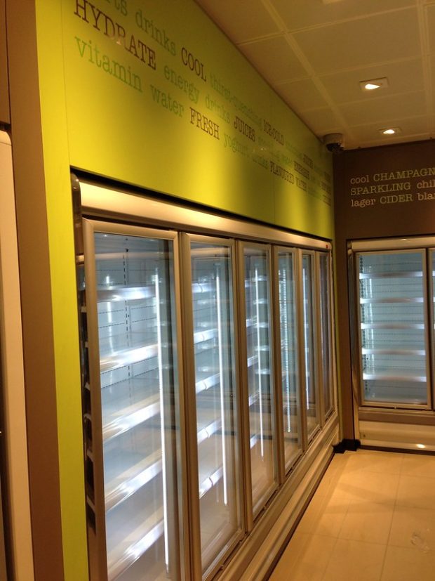 Row of refrigerators set into the wall.