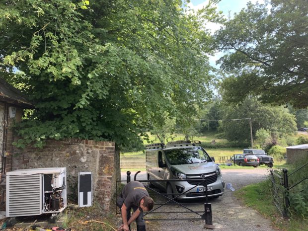 Engineer inspecting air conditioning system outside.